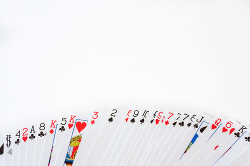 Preview: Deck of cards deployed with a white background and space for text.
