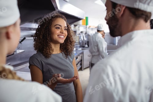 Preview: Restaurant manager interacting with his kitchen staff