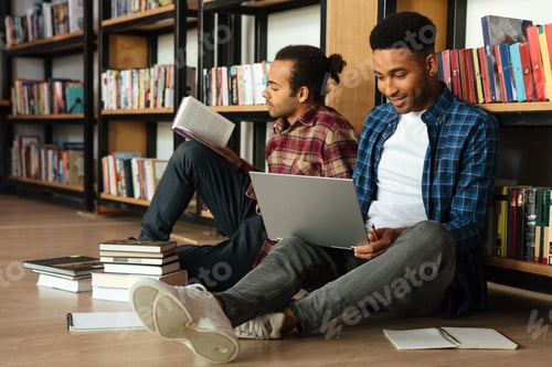 Preview: Young two african men students sitting in library