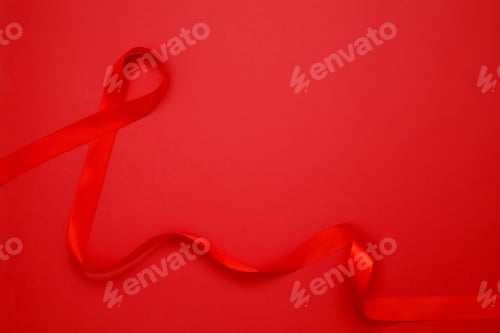 Preview: Red ribbon with awareness about AIDS on a red background. World AIDS Day