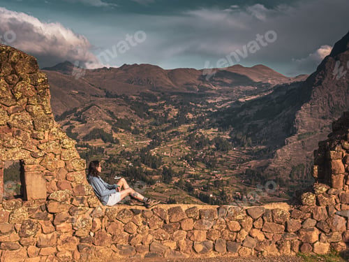 Preview: Woman relaxing with a view from Pisac ruins, Peru