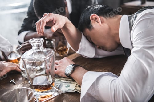Preview: drunk colleagues sleeping at table while spending time together after work
