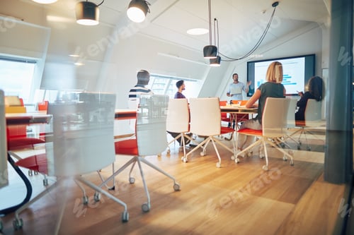 Preview: Manager discussing graphs with staff during an office meeting