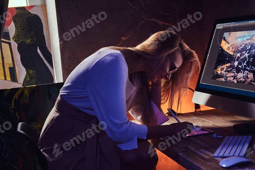 Preview: Young woman is working at home office