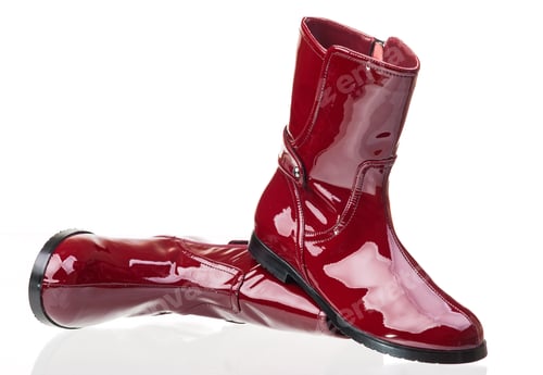 Preview: Pair of red patent leather female boots over white