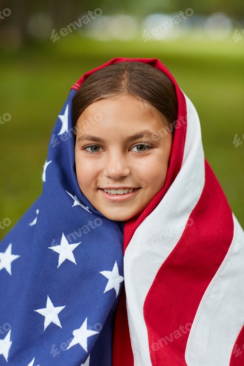 Preview: Smiling Girl Covered by Flag Blanket