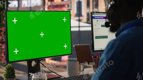Preview: Technical support specialist in call center office using green screen PC