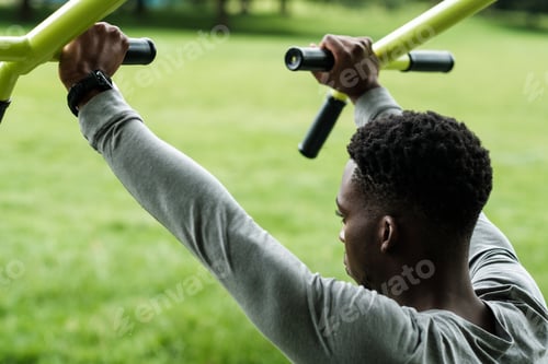 Preview: Portrait of black male working out outdoors in a park.