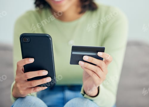 Preview: Woman Holding Phone and Credit Card Indoors