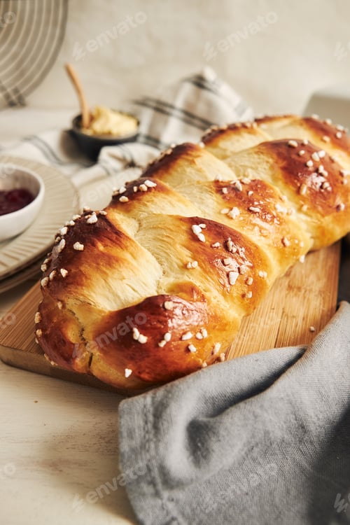 Preview: Vertical shot of delicious sweet yeast bread on a white table