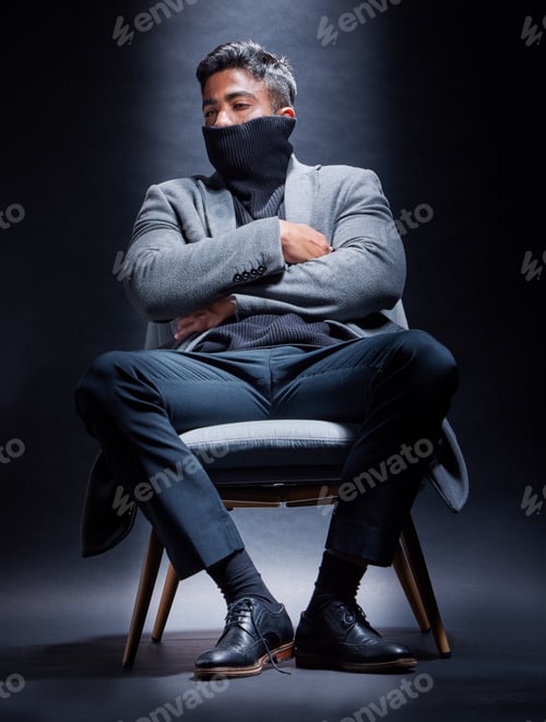 Preview: Studio shot of a handsome and fashionable young man posing against a dark background
