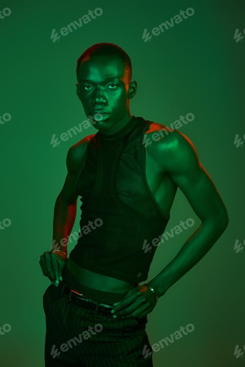 Preview: Stylish young man exudes vibrant energy in captivating artistic lighting setting