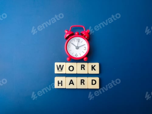 Preview: Red alarm clock and toys word with word WORK HARD.