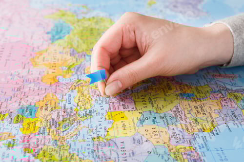 Preview: Travelling background. Hand tackling county on the map