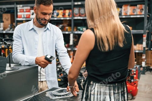 Preview: Making a purchase. Man with woman are in the hardware store