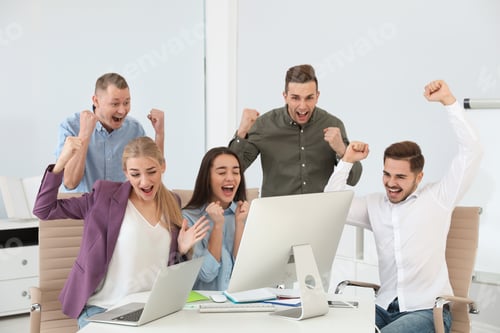 Preview: Group of office employees celebrating victory at workplace