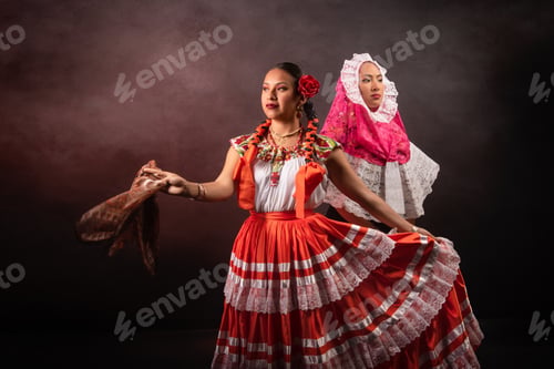 Preview: Two women in traditional Mexican clothing are dancing
