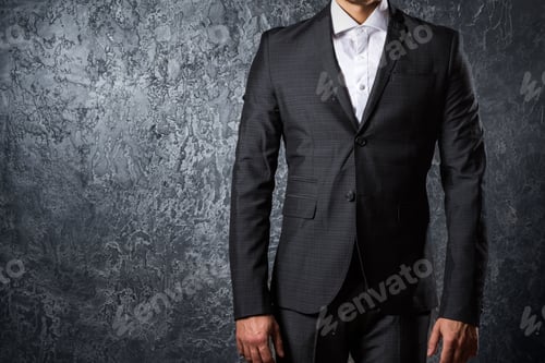 Preview: Man in suit against concrete wall