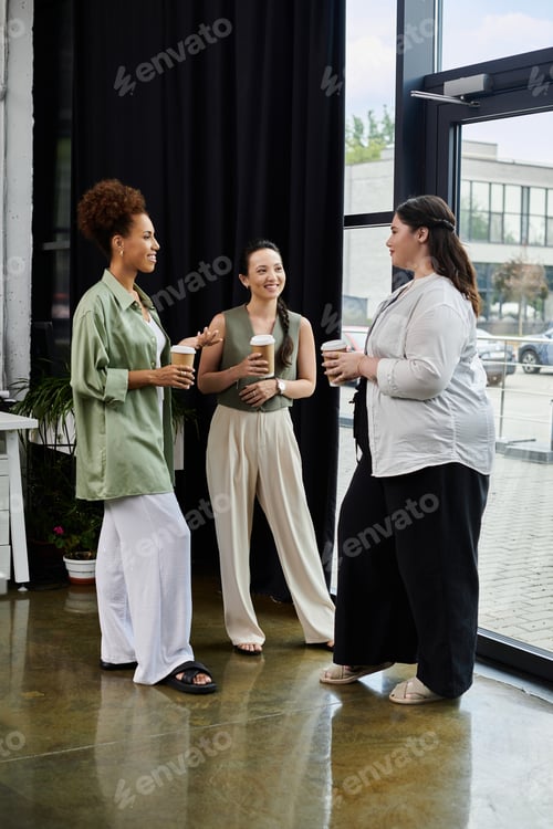 Preview: Three elegant businesswomen enjoying a collaborative moment in a modern office space