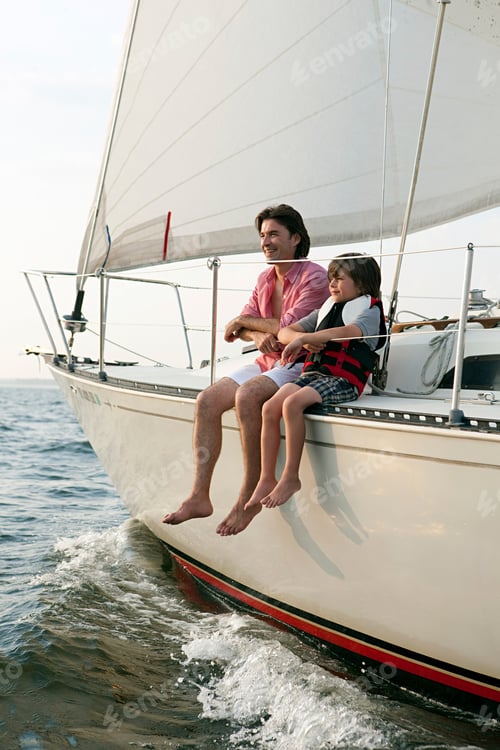 Preview: Father and son sitting on yacht