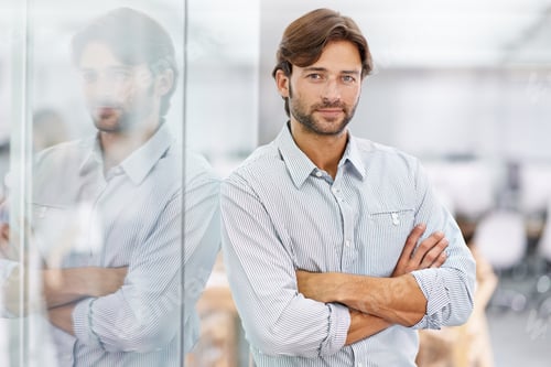 Preview: Hes a confident young businessman. Portrait of a handsome young businessman standing in his office.
