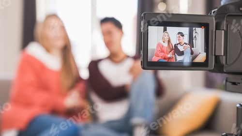 Preview: Young youtubers or bloggers creating content for social media while making a video at home.