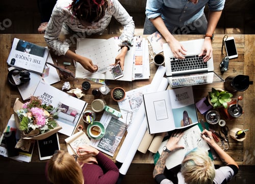 Preview: Flatlay of colleagues working at a desk