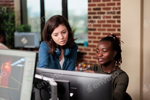 Preview: Multiethnic coworkers in conversation about graphic developing technology and how to improve it.