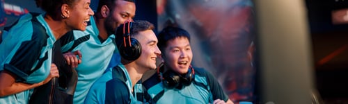 Preview: Happy gamers involved in online video game at computer club