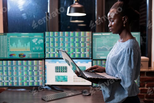 Preview: Forex stock market company professional trading agent using laptop to analyze live financial graphs