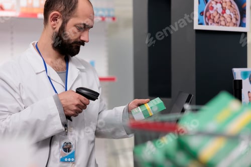 Preview: Pharmacist holding store scanner that reads the barcodes on all the pills and packages