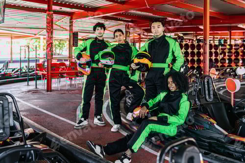 Preview: Friends in Racing Suits Pose at Indoor Track