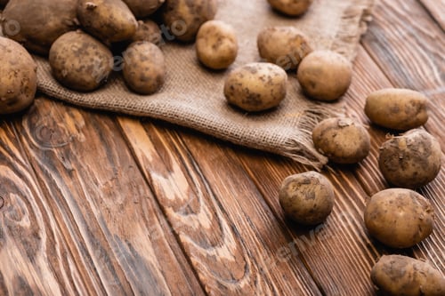 Preview: dirty potatoes and burlap on wooden table