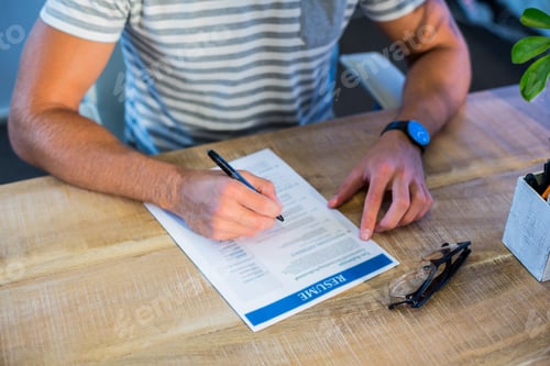 Preview: Man Writing Curriculum Vitae At His Desk