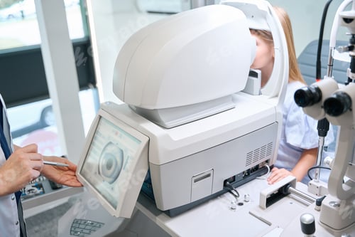 Preview: Optometrist determining patient eyeglass prescription using autorefractor