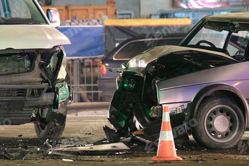 Preview: Damaged in heavy car accident vehicles after collision on city street crash site at night.