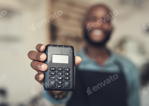Preview: Shot of an unrecognizable man standing in his bicycle shop and holding a card machine