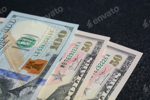 Preview: Hundred and Fifty Dollar Bills on Dark Surface