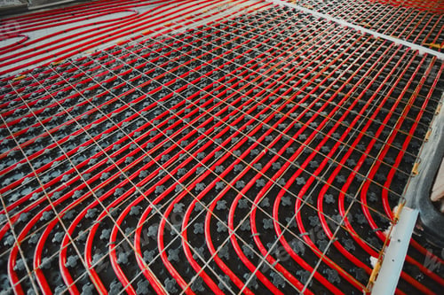 Preview: Installing underfloor heating system with red pipes on insulation panels