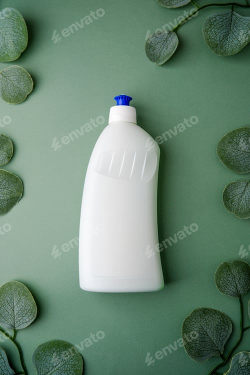 Preview: White plastic bottle with blue cap surrounded by green eucalyptus leaves on a green backdrop.