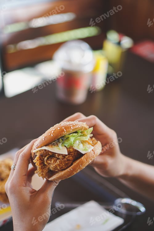 Preview: tasty burger. stylish hipster woman holding juicy hamburger in hands close up.