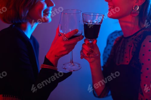 Preview: Young Women Enjoying Drinks in Club