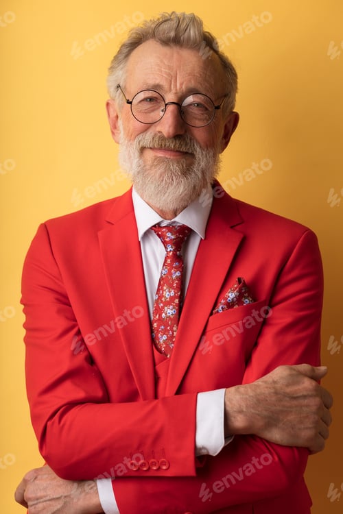 Preview: Happy smiling senior executive businessman in fashionable red suit with necktie.