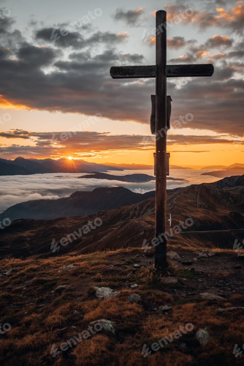 Preview: Cross with beautiful mountains in the background during the sunset in South Tyrol