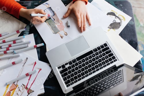 Preview: Top view of woman hands drawing fashion illustrations with lapto