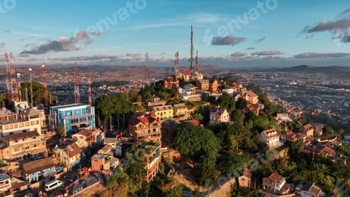 Preview: Aerial view of Antananarivo at sunset highlighting its colorful buildings and lush hillsides