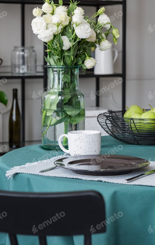 Preview: White flowers in glass vase on dining table in trendy interior