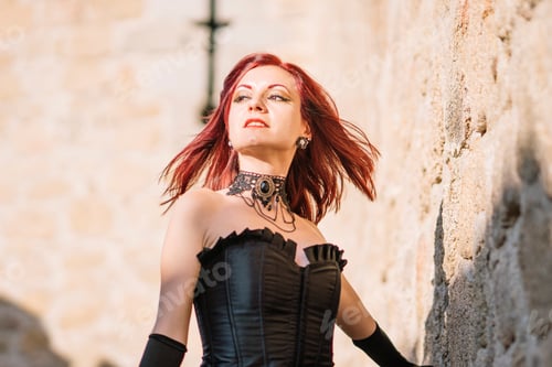 Preview: Pretty red haired medieval girl poses together castle.