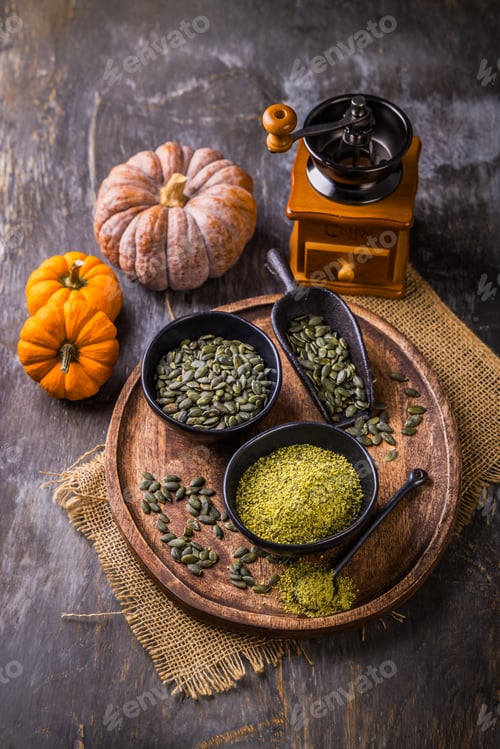 Preview: Pumpkin seed flour in a bowl with seeds, healthy food concept