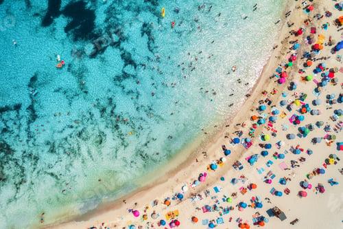 Preview: Aerial view of sandy beach with umbrellas and sea